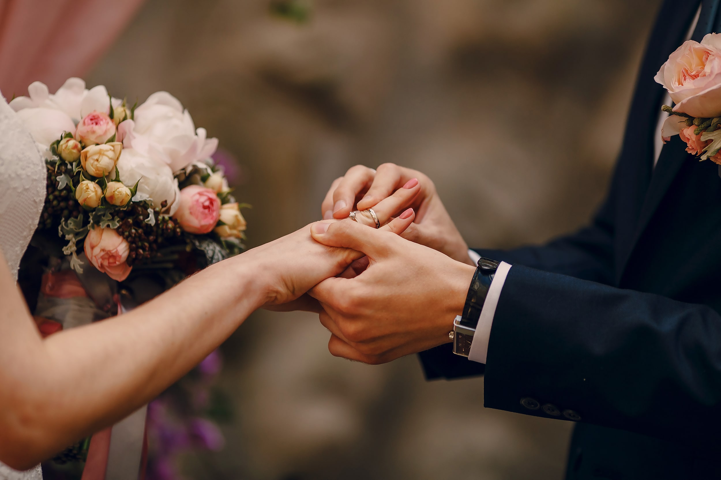groom-putting-ring-on-bride-s-finger-min